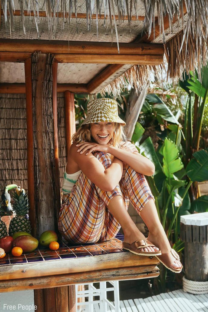 Models poses in a tiki hut for Free People