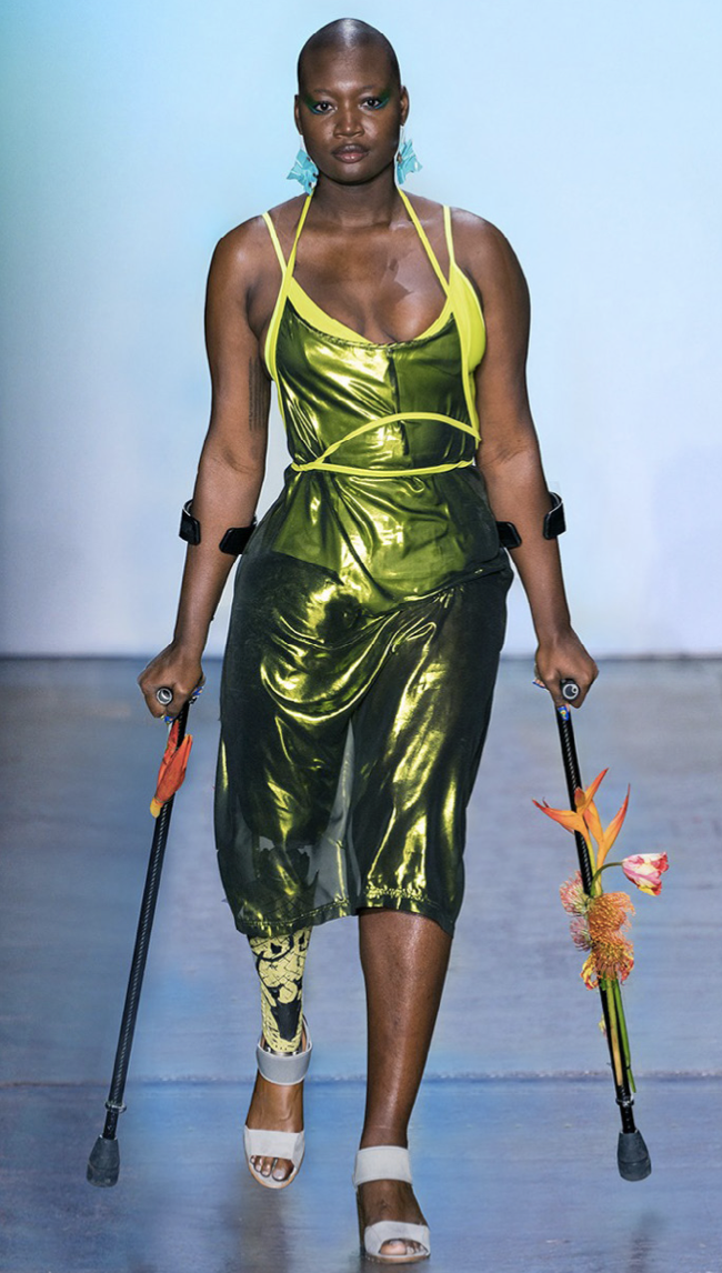 Model walks down runway in crutches